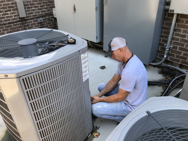 repairman fixing air conditioner