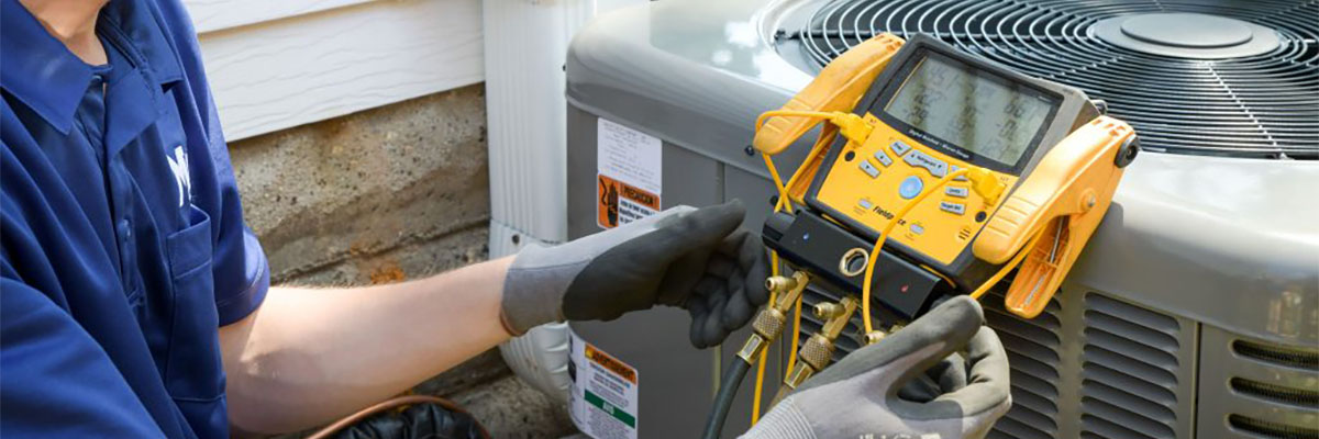 technician testing air conditioner