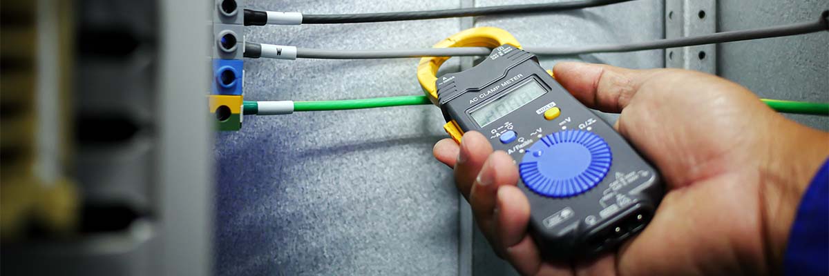 technician using a clamp meter